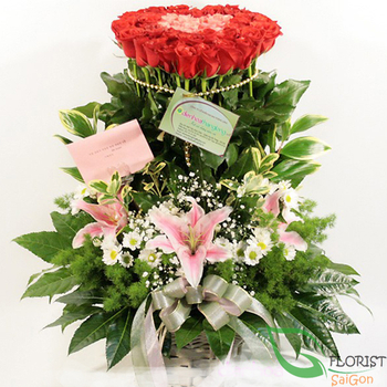 Basket of red roses and lilies