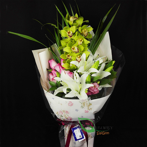 A flower bouquet with orchid and lilies