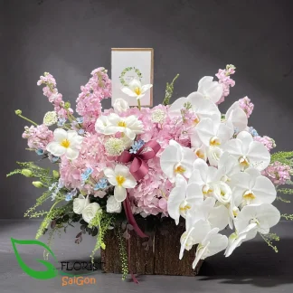 Luxury basket of mixed flowers with white orchids, tulips and pink hydrangeas in Ho Chi Minh City