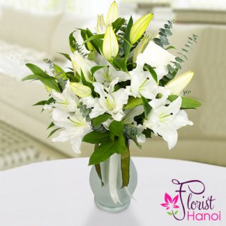 White lilies in glass vase
