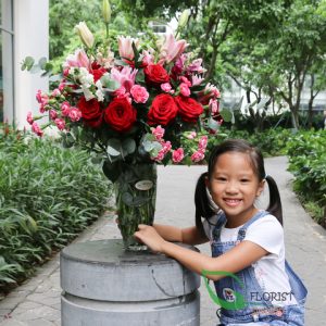 Red roses and lily flowers in vase