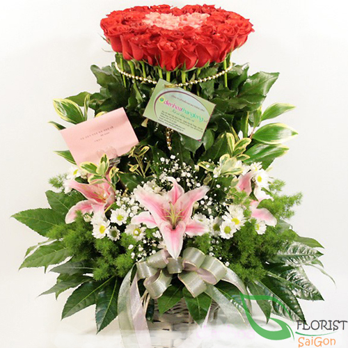 Beautiful basket of red roses and pink lilies